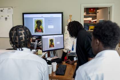 Two teenagers and Nakessa face away from the camera, looking at Chris Ofili’s ‘No Woman, No Cry’ projected on both the computer and video screen.