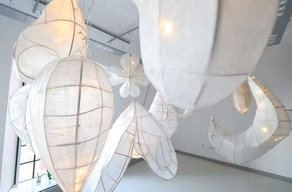 A photo of hanging paper artworks in the Clore Studio at Tate Liverpool