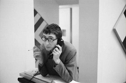 Photograph of John Kasmin at the desk in his gallery during an exhibition of paintings by Kenneth Noland in 1967