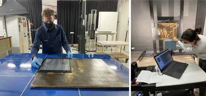 People working closely with a painting using technical equipment