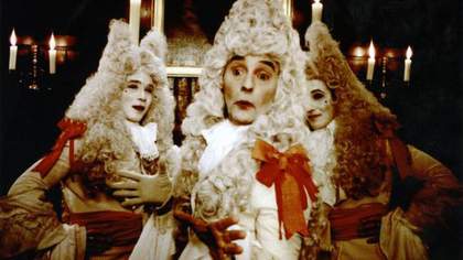 Three theatrical men in white wigs