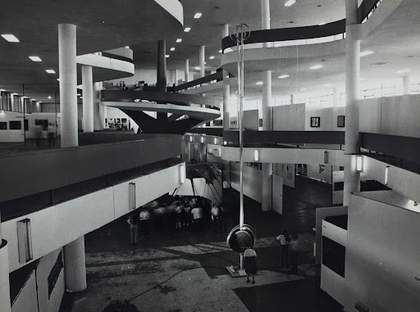Photograph showing all the different open levels of the pavilion with columns running the full height of the space