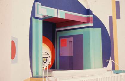 A photograph of a doorway which has been painted all over with abstract blue, purple, red, pink and blue motifs