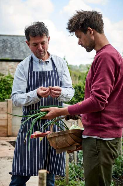 Two people collecting crops