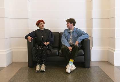 Two people sitting on a sofa