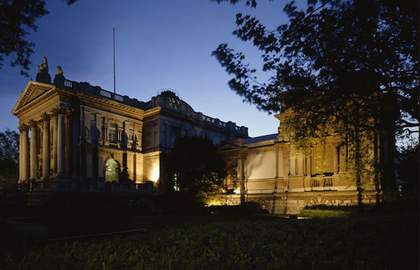 Architecture tour Tate Britain showing a photo of Tate Britain lit up at night