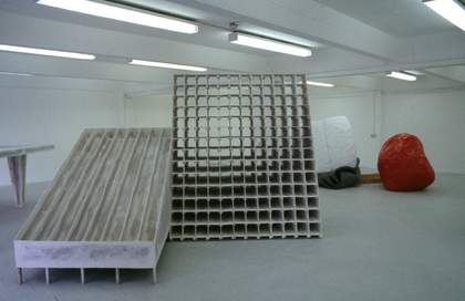 Two large wooden objects - one on the floor and one standing up