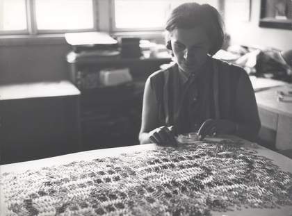 Běla Kolářová working on an assemblage with paper clips, photographed by André Villers, 1969
