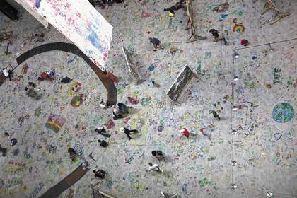 A birds eye view of the floor of the turbine hall during Mega Please Draw Freely, covered with drawings 