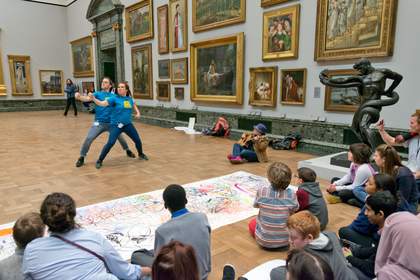 Two dancers performing to a crowd in the gallery