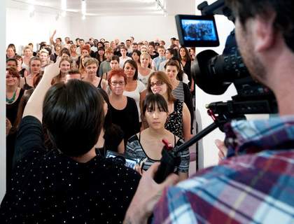 A group of participants gather as part of Emily Roysdon's performance I am a helicopter, camera, queen