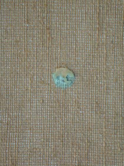 Detail of reverse of canvas where turquoise paint has seeped through hole