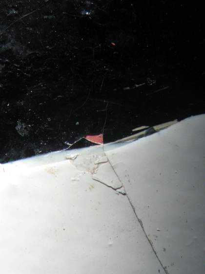 Detail of lower-right edge of ball, revealing pink paint under a loss