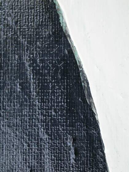 Detail of turquoise paint visible between the black leg and white background