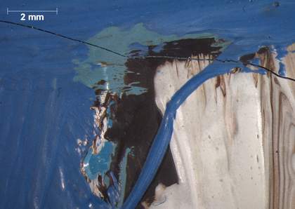 Micrograph of upper left corner of the window on the right, showing three types of blue: one in the underlayer and two on top