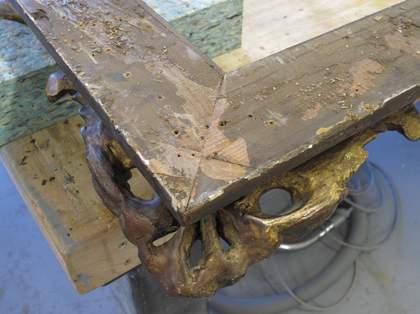 A detail of a corner with the upper layer of wood from the build-up removed revealing the altered mitre keys beneath