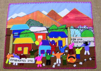 Brightly coloured textile collage: in the background are houses and trees in front of mountains; in the foreground figures wave arms in the air and hold up signs reading e.g. POR UNA EDUCACION GRATIS
