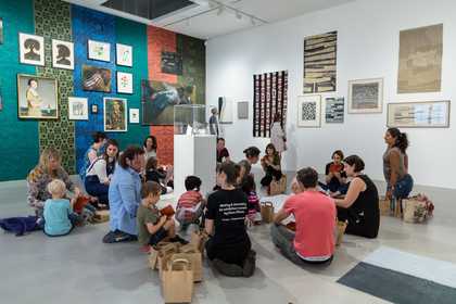 Photograph of two people viewing a painting