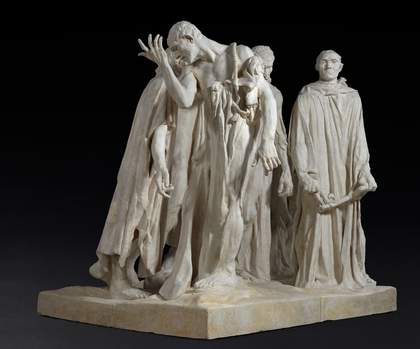 The Burghers of Calais sculpture against a black background 