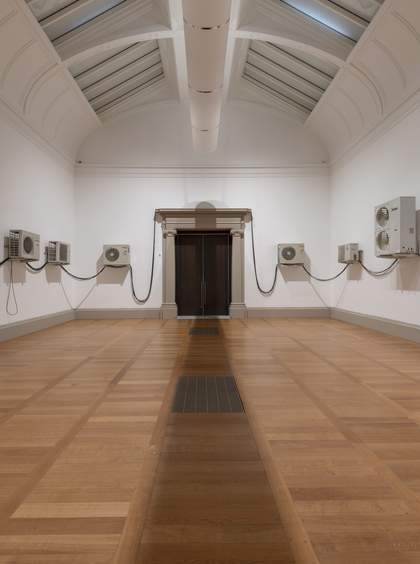photo of a gallery room with air conditioning units arranged along the walls
