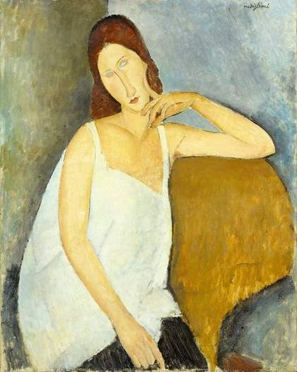 a woman sits in a chair
