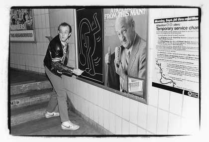 Keith Haring drawing on a subway platform, New York City, c1982