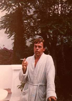 Image of Kenneth Halliwell smoking in his dressing gown