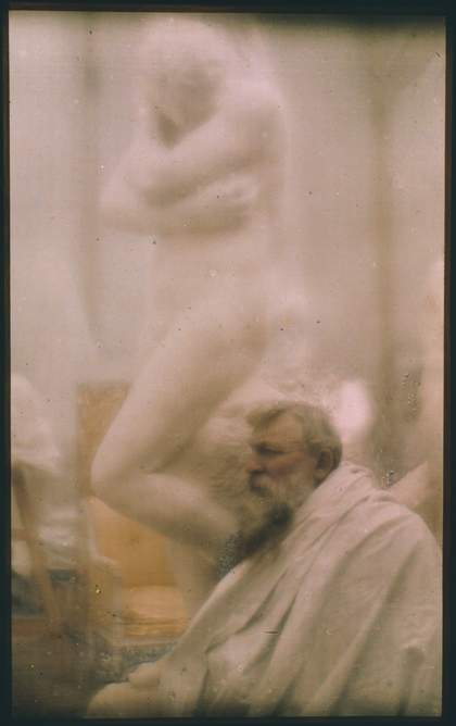 Colour photograph of Auguste Rodin in front of his plaster model