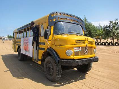 Emeka Udemba’s Molue Mobile Museum of Contemporary Art, driving on the beach in Cotonou, Benin, 2014