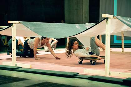 Rolling underneath a reproduction of Jutta Koether's painting La Femme, 2006 during Ei Arakawa's Kissing the Canvas performance 