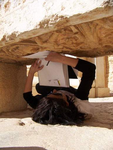 Drawing at Palmyra photograph from Nahnou Together exhibition at Tate Britain showing a women doing a rubbing of a stone freize