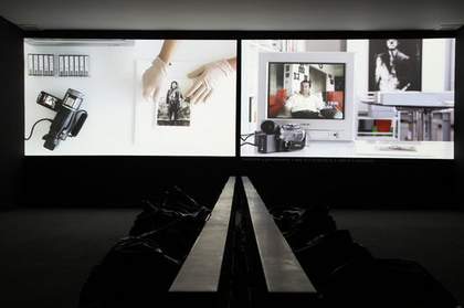 Akram Zaatari On Photography People and Modern Times 2010 two video projections side by side one showing a camcorder and photograph and the other showing the camcorder and a television