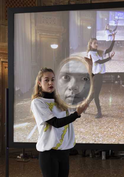 Performer holding a mirror