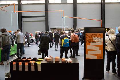 a crowd of people looking around stalls