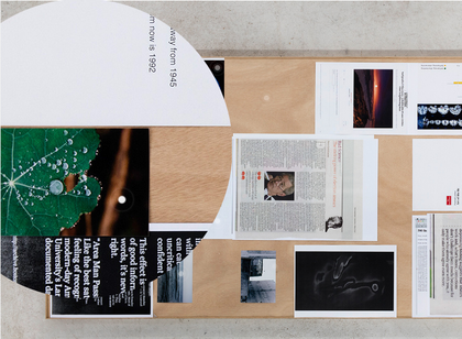 Colour photograph of a table with newspaper cuttings on it