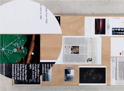 Colour photograph of a table with newspaper cuttings on it