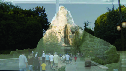 Landscape photograph showing a small crowd of people walking away from the camera 