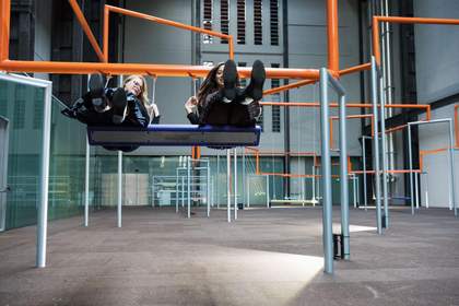 two woman sit on the swings