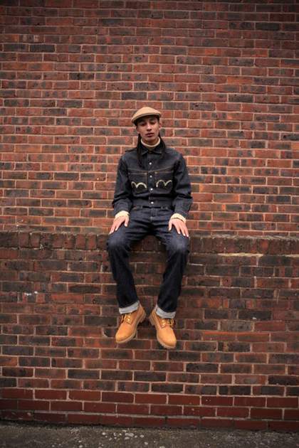 What We Wore Project with Nina Manandhar; man seated on brick wall