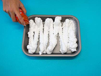 a baking tray filled with shaving foam 