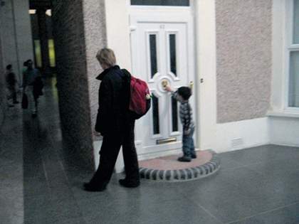 Video still of spectators looking at Michael Landys installation Semi detached at Tate Britain four
