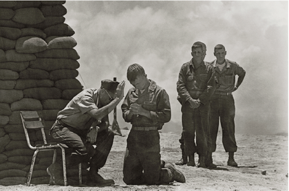 On a hill in Da Nang, Vietnam, a priest hears soldiers' confessions, 1969